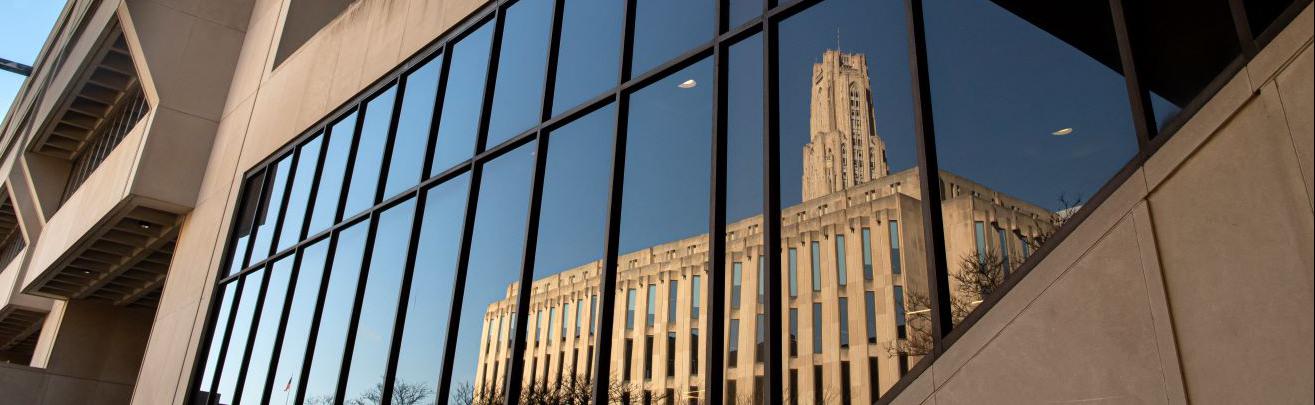 Reflection of Cathedral of Learning in a Pitt campus building